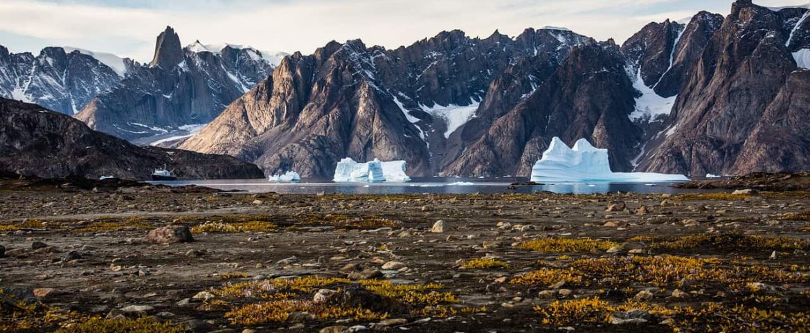 Snow-covered glacial landform in mountain range.