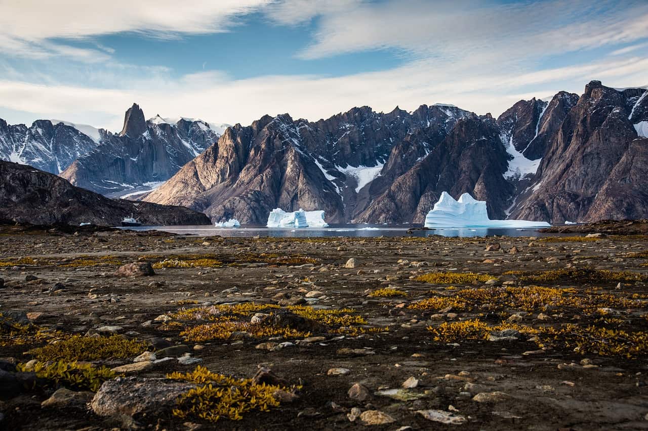 Snow-covered glacial landform in mountain range.