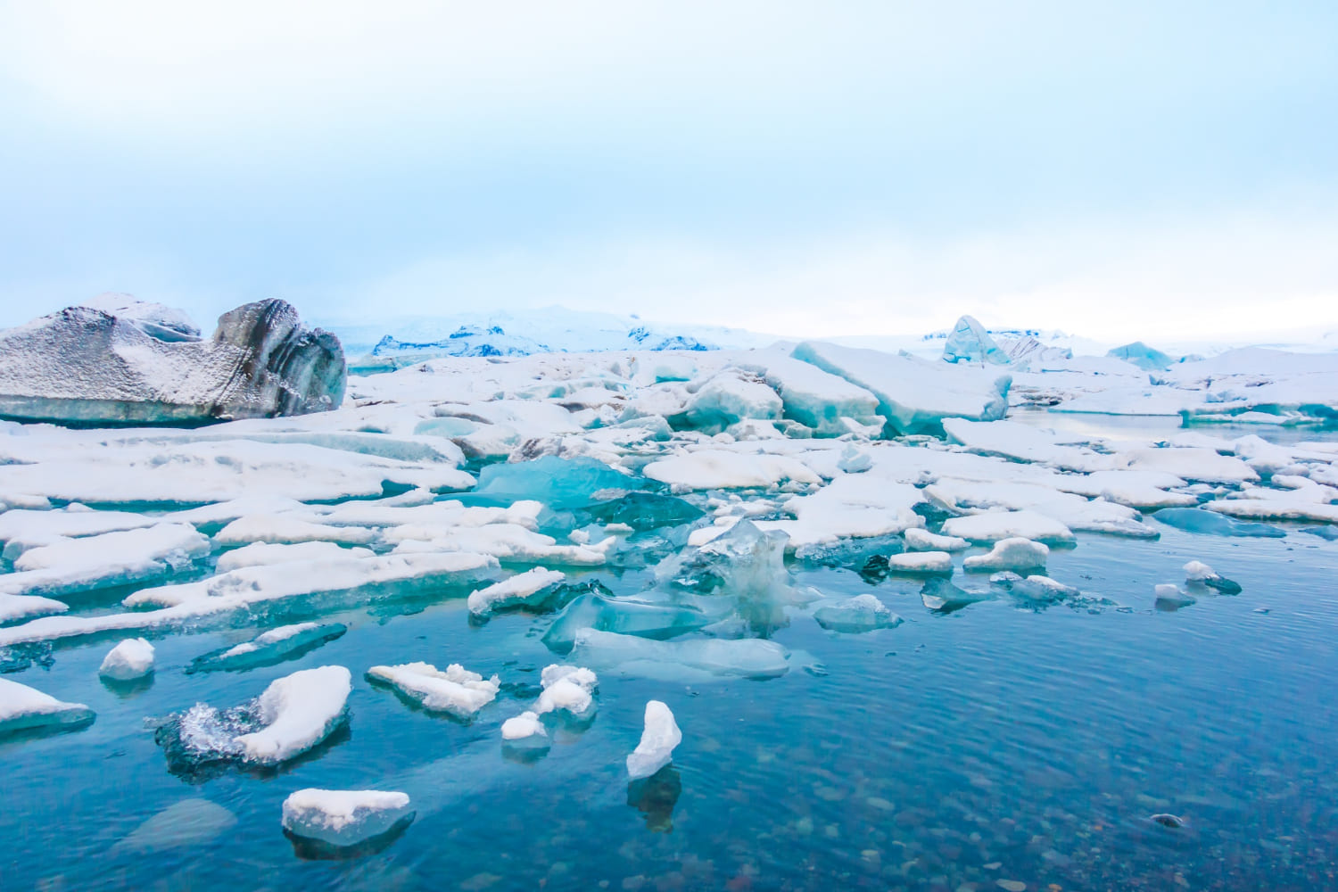 Blue polar ice cap surrounded by sea ice and snow.
