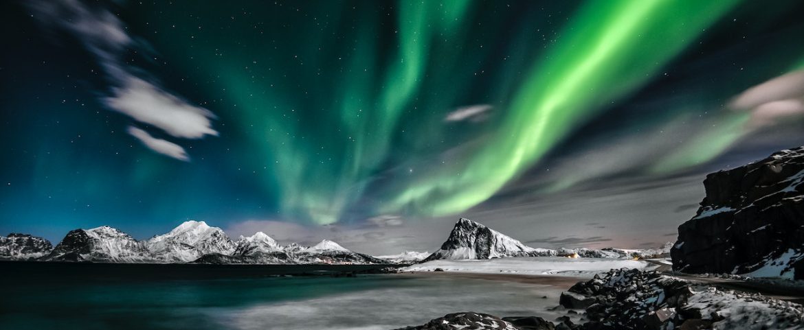 Aurora over Arctic glacier at night.