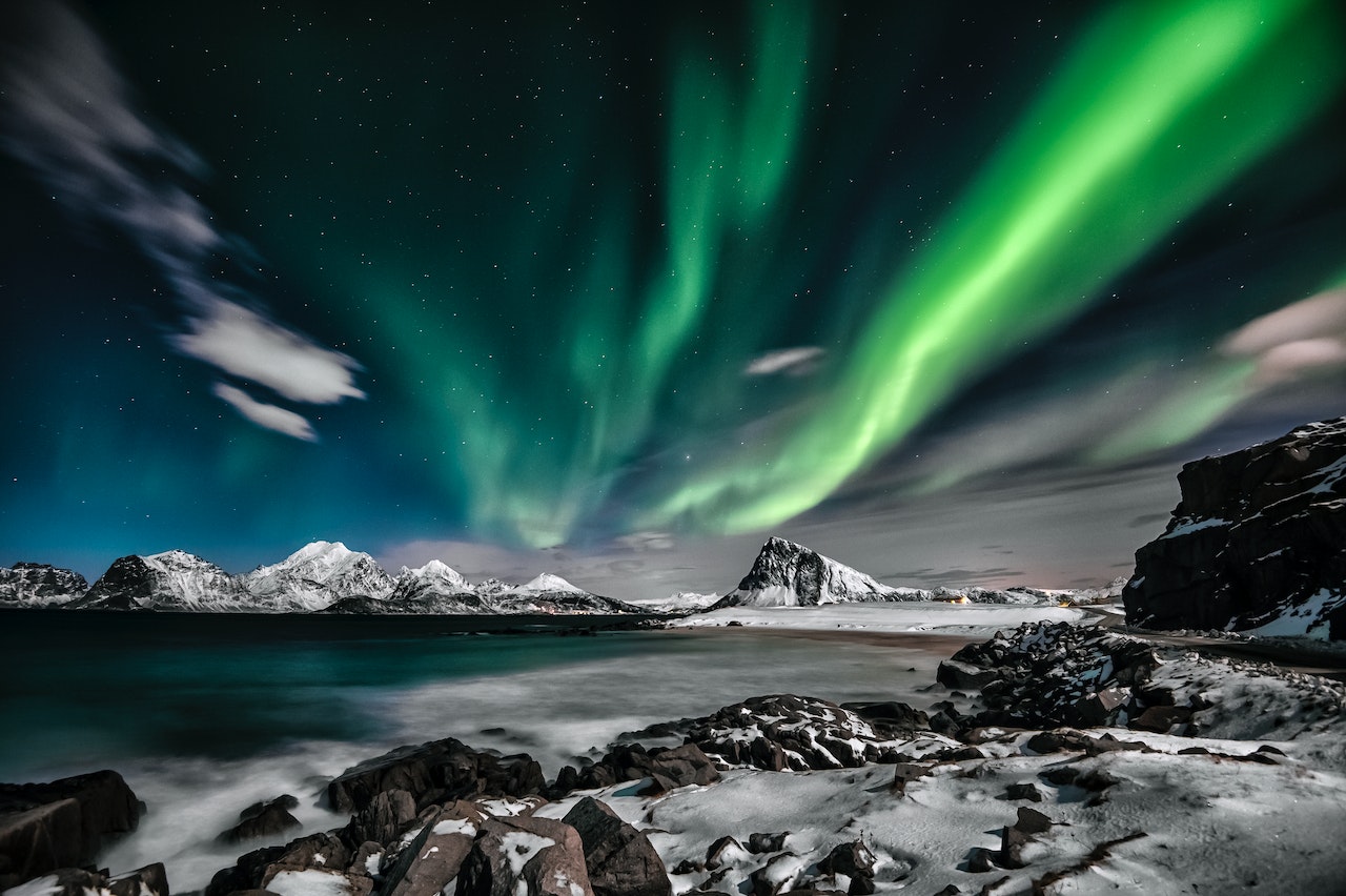 Aurora over Arctic glacier at night.