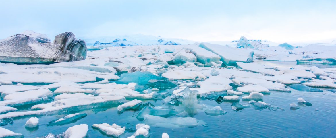 Blue polar ice cap surrounded by sea ice and snow.