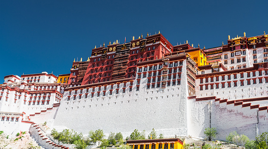 The majestic Potala Palace building standing tall under a clear blue sky.