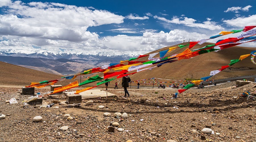 Tibetan prayer flags fluttering in the wind across mountains.