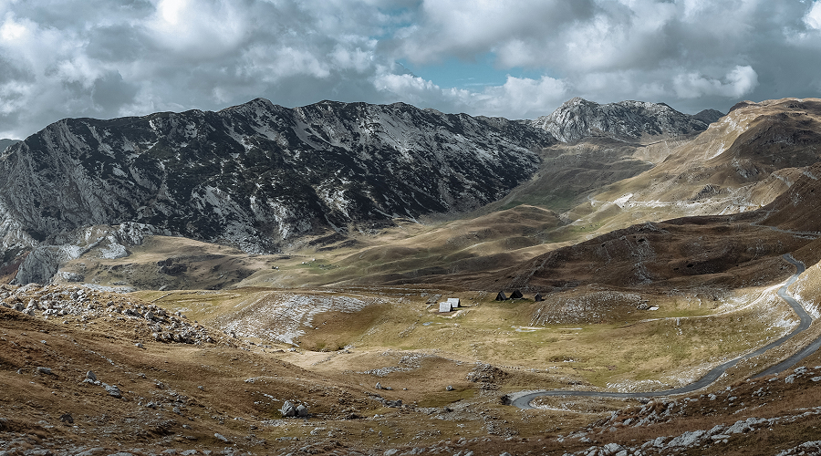 Winding road through the rugged Himalayan plateau mountain valleys.
